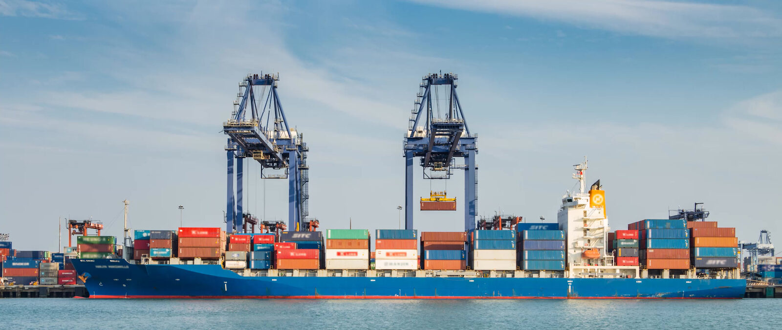 Container ship under gantry cranes at a Cyprus port